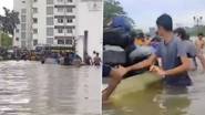 Chennai Rains: వీడియో ఇదిగో, నడుం లోతు నీళ్లలో చొక్కాలు విప్పి విద్యార్థులు అవస్థలు, చెన్నై నగరాన్ని అస్తవ్యస్తం చేసిన వరదలు